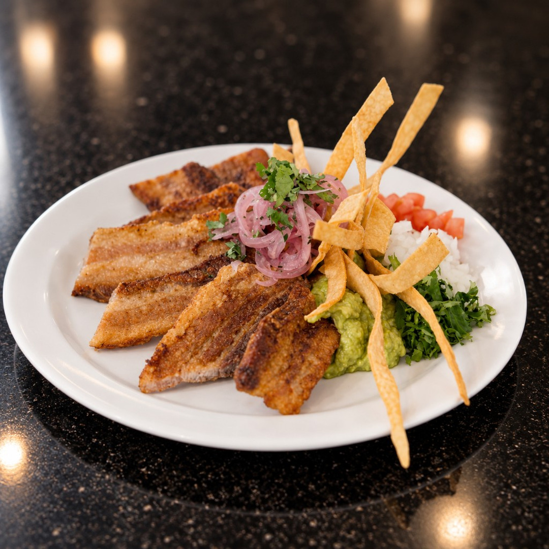 Chicharrón with guacamole, rice, and pickled onion at Salsa Roja Dallas